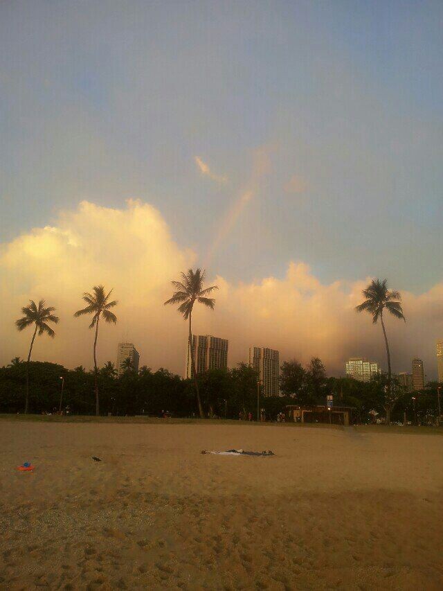 look at the beautiful rainbow at the seaside.
