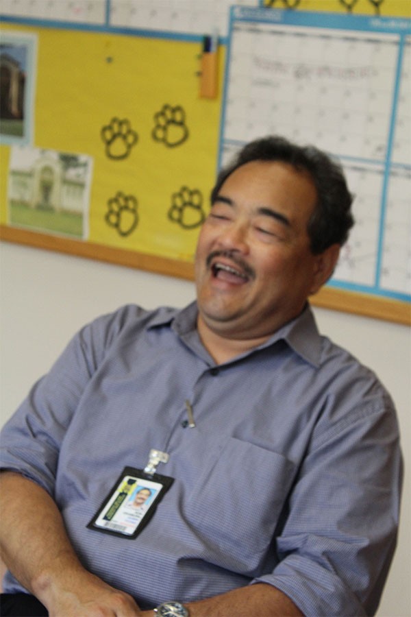 Principal Ron Okamura laughs at memories from his time as a principal.    