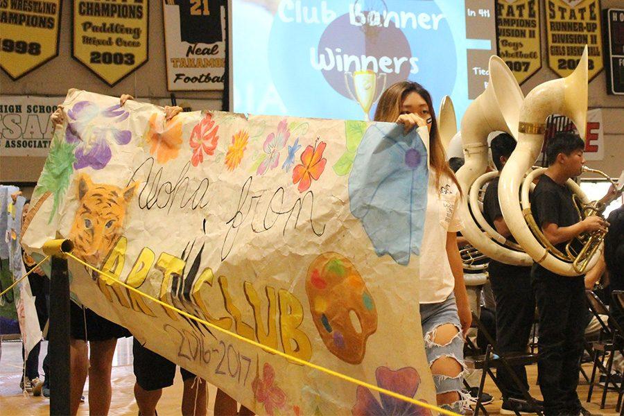 Art club presents their banner to the court.