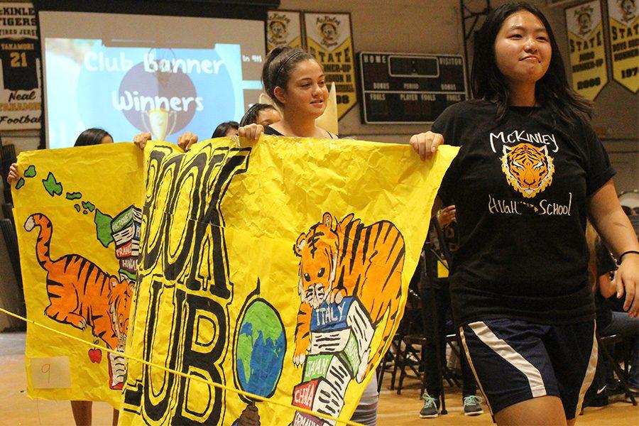 Book club features their banner to the court.