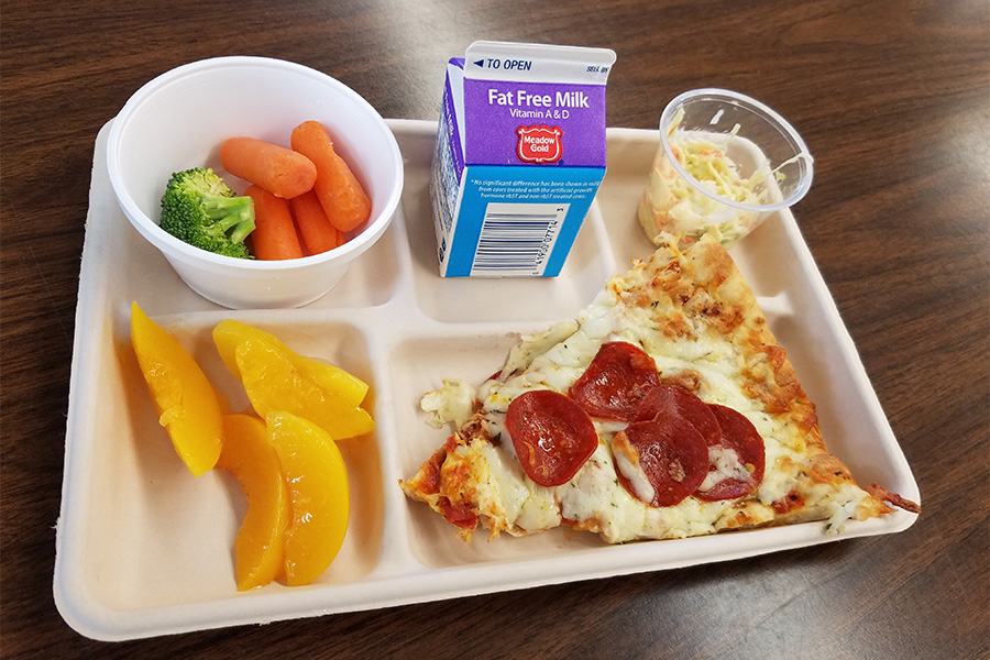 Example of one of the lunches served at MHS, it features pizza, milk, peaches, vegetables and coleslaw. 