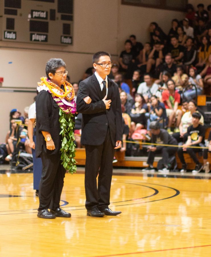 Okuda advises the National Honor Society. NHS president Jordan Lam escorted Okuda during the Hall of Honor Assembly.