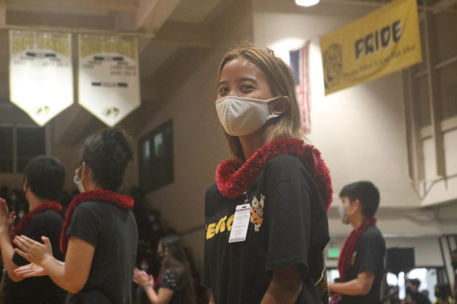 Senior Amanda Begonia smiles in pride of having the privilege to stand on the court for the announcement of college/scholarships at the Aloha Assembly.