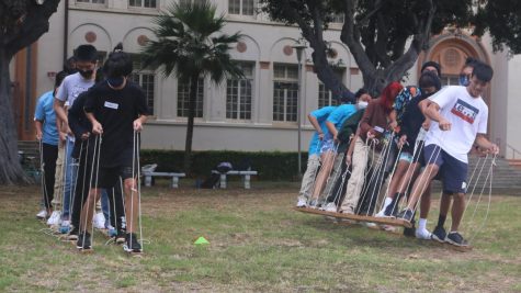 Freshmen and Ignition students collaborate to race across the field on the skis 