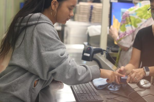 A student is getting her finger scanned. Photo by Jerome Linear.