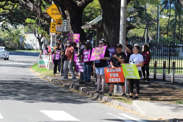 On Feb.17, to honor the anniversary of Sara Yaras death, family members, friends, police officers and legislators waved signs regarding driving laws and pedestrian saftey awreanres. Photo by Shane Kaneshiro