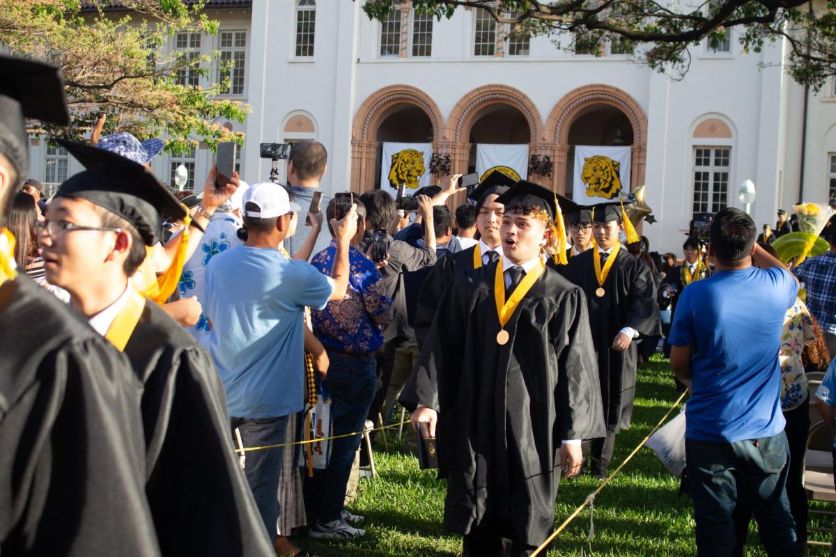 The graduating class of 2024 walks across the oval and onto the front lawn, to greet their friends and families.

Photo by Dominic Niyo