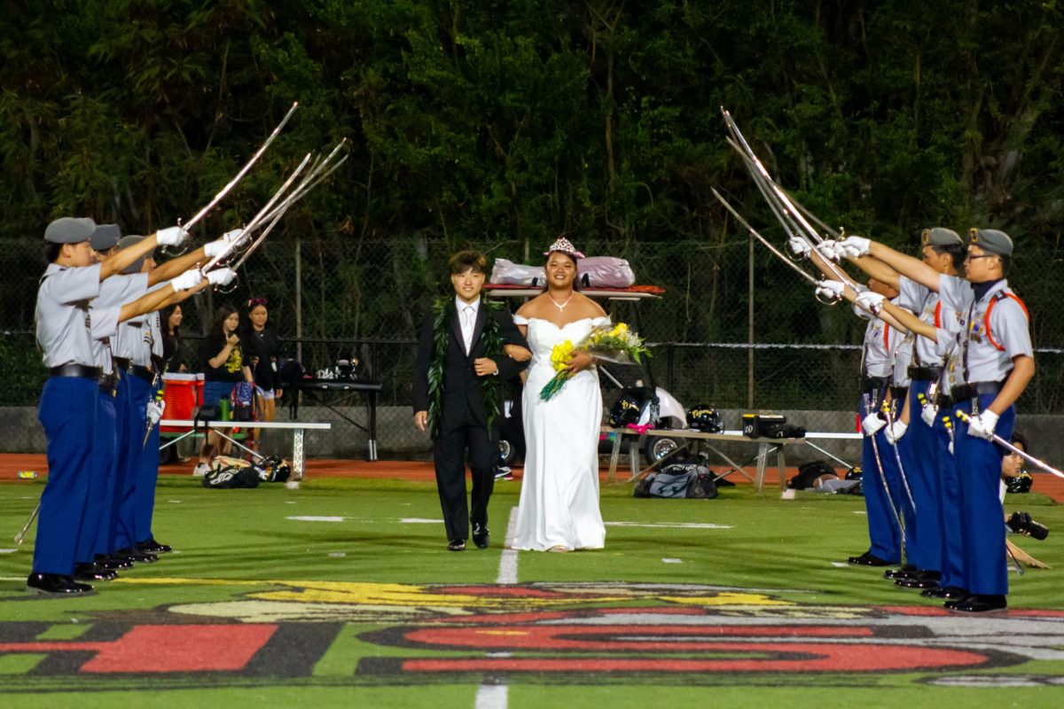 McKinley’s JROTC Saber Squad presents Homecoming King Brayden Kaneko and Homecoming Queen Angriel Olap during halftime.