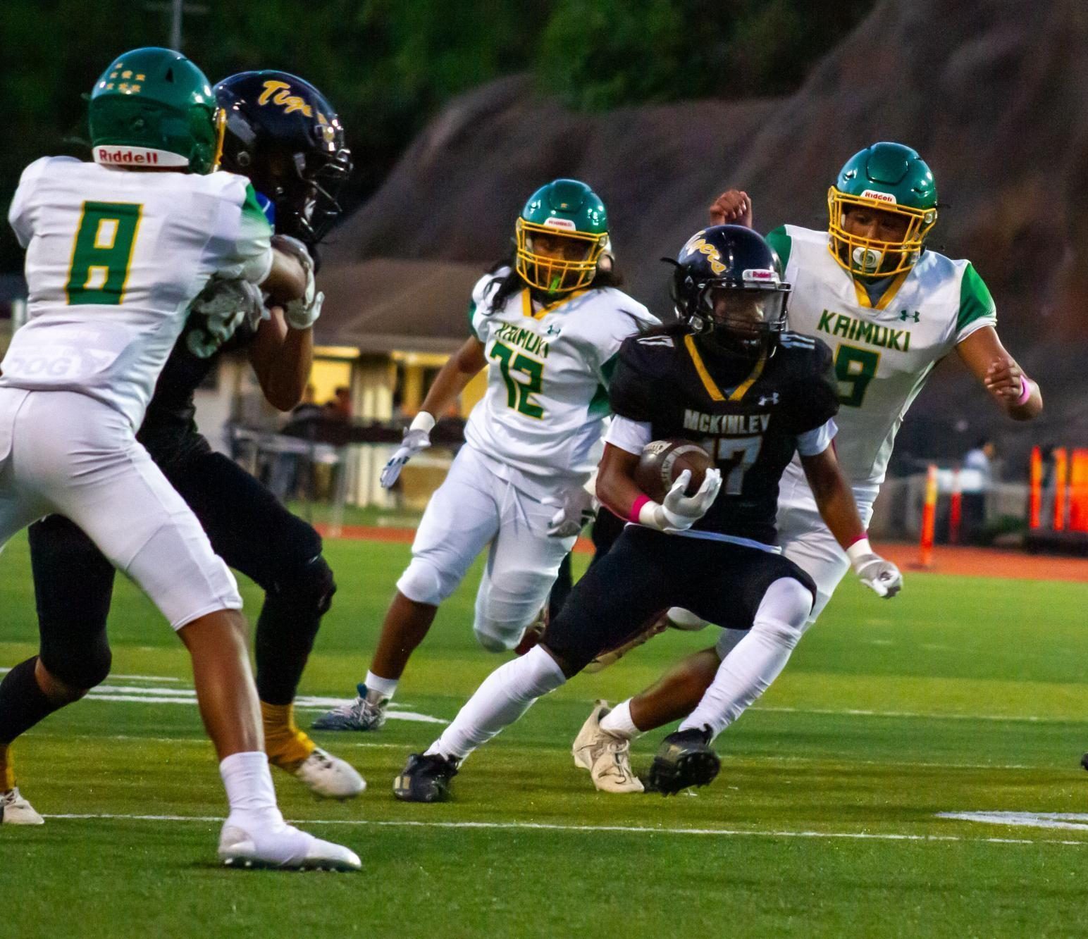 Defensive back Jerome Artem (17) attempts to evade three Kaimuki defenders in the first quarter before being tackled.
