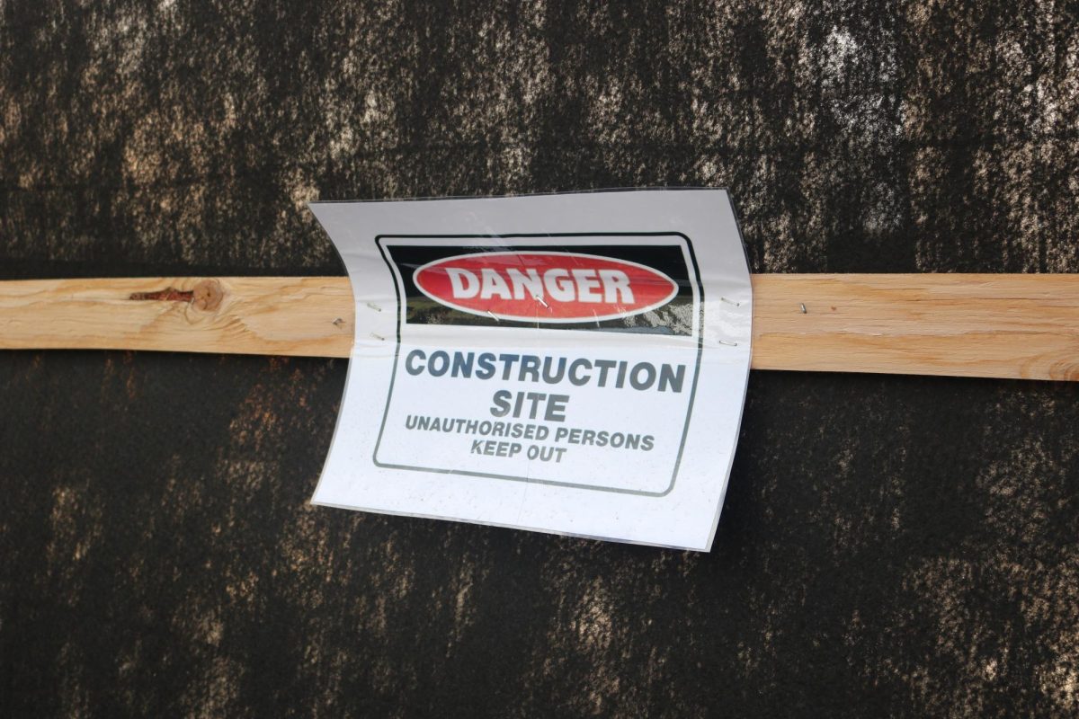 The bleachers' construction site sign at the football field.