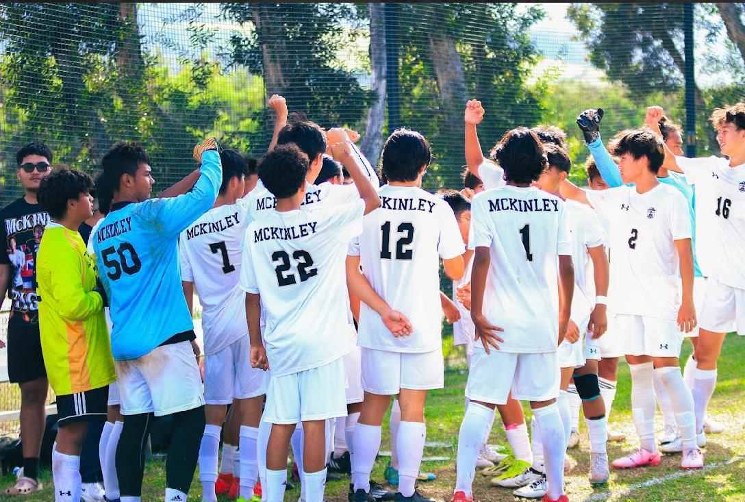 The Boys Soccer team huddle up during the game to boost their morale.