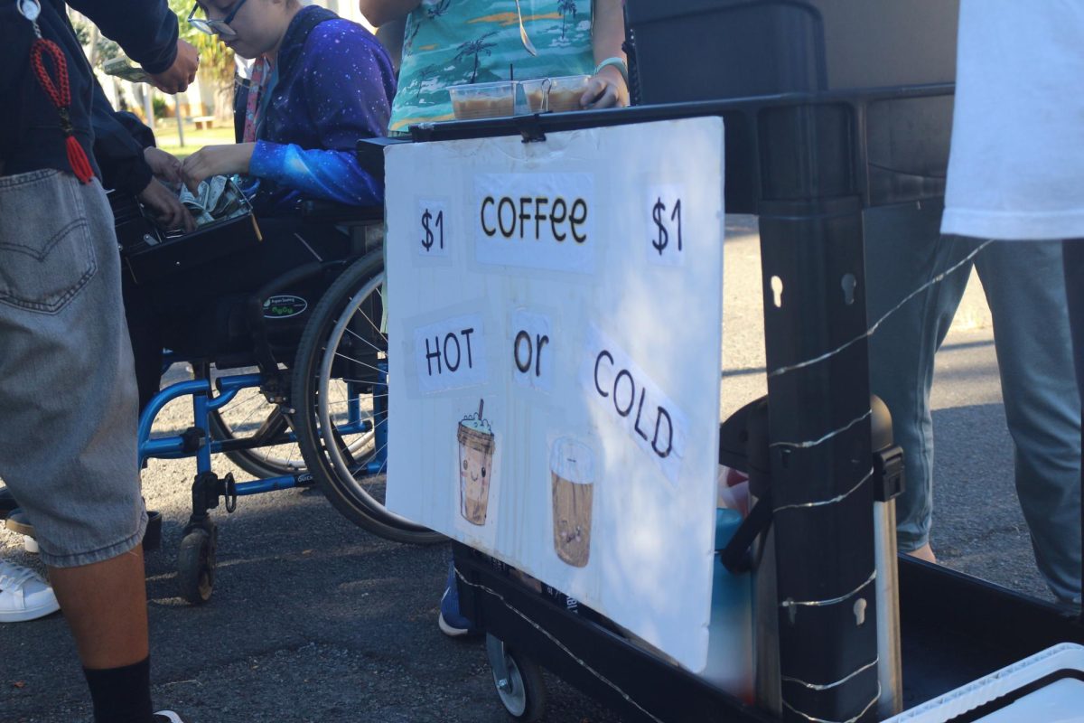 The coffee cart ran by the CBI students and teachers which is parked in front of W Building, being sold for one dollar. Some students are in charge of the money while others are taking orders. Photo by Cheska Orias