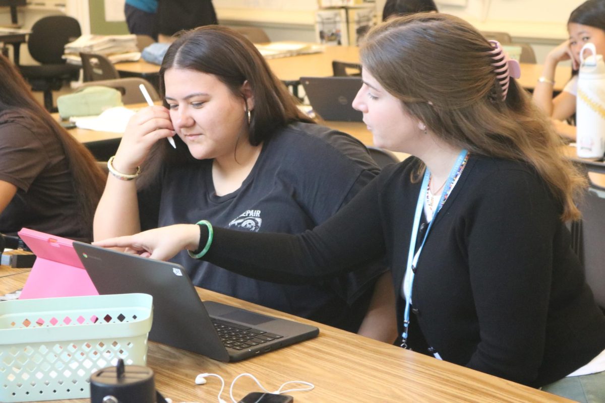 Poli' Cootey-Garcia (c/o'28) receives help from student teacher Kelsey Paulseth on her 7-11 review article . " she is a very nice and genuine person, who also gives amazing advice that you usually hear from a close friend."
Photo by Kena Anien .